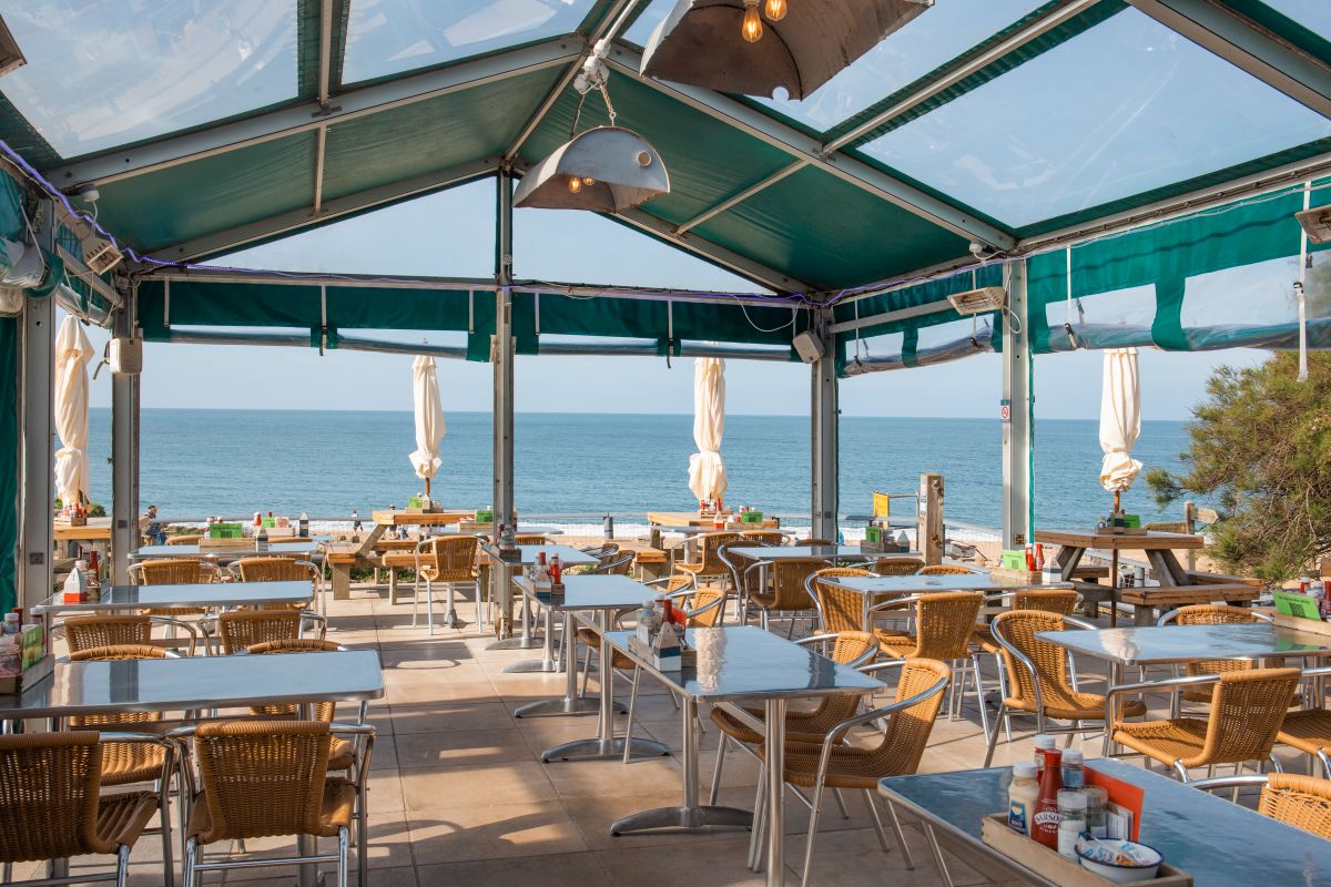Covered seating area looking out to sea at Hive Beach Café, Dorset